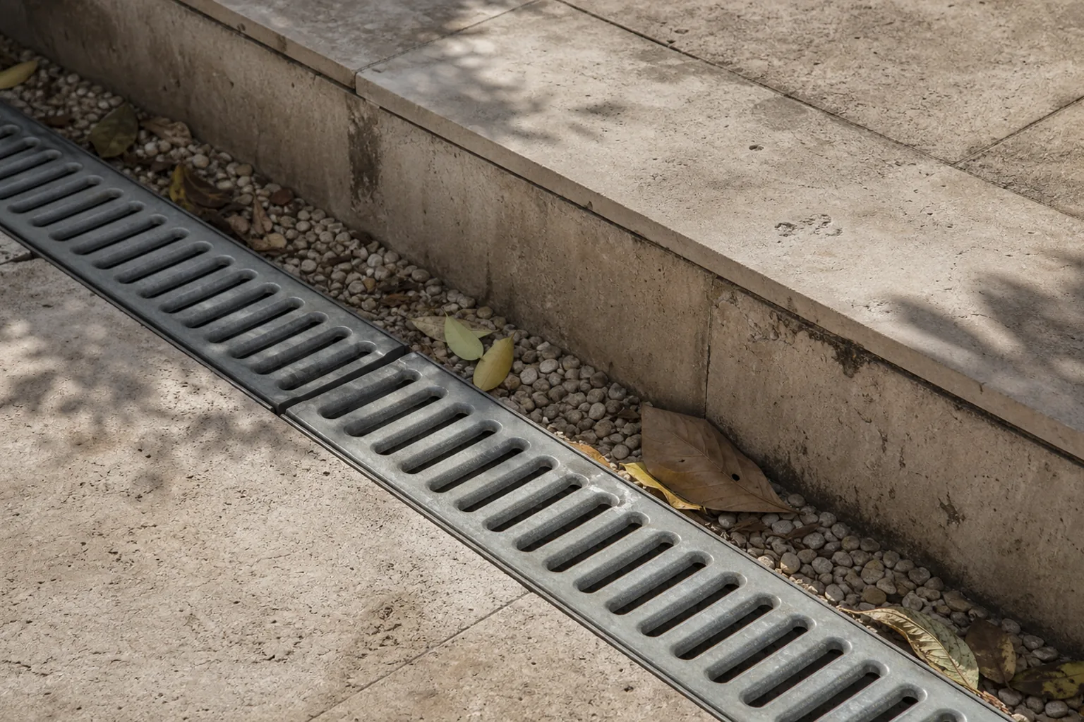 A linear drain and small level change beside paving show site conditions that an attractive garden render cannot assess.